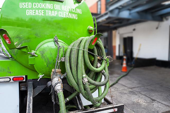 a service truck pumping grease from a restaurant's grease trap in Walnut Springs